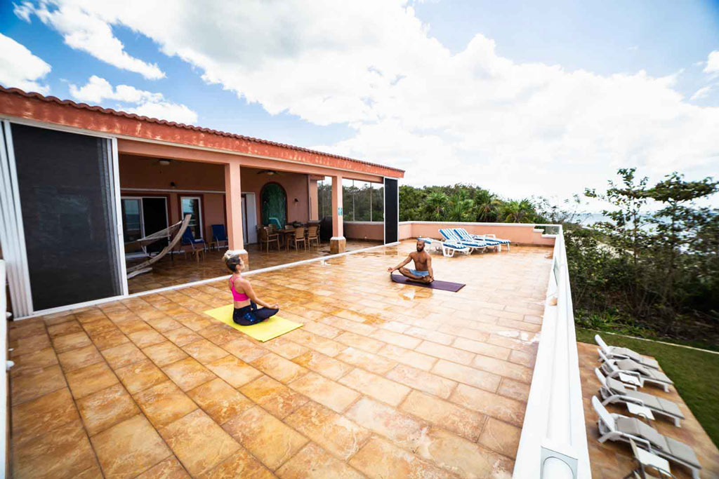 Couple meditating on the terrace